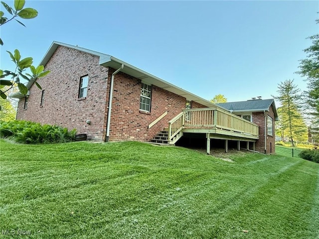 305 Flintwood Dr, Marietta, OH 45750 - back of property featuring a wooden deck, a lawn, brick siding, and stairway