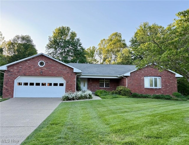 305 Flintwood Dr, Marietta, OH 45750 - ranch-style home featuring an attached garage, a front yard, driveway, and brick siding