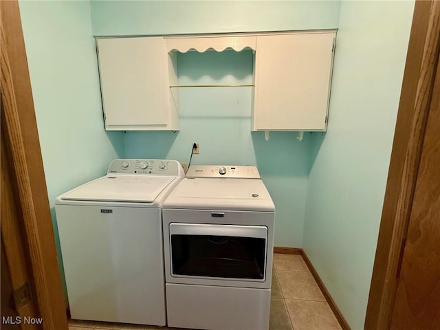 305 Flintwood Dr, Marietta, OH 45750 - laundry area with cabinet space, washing machine and dryer, baseboards, and light tile patterned floors