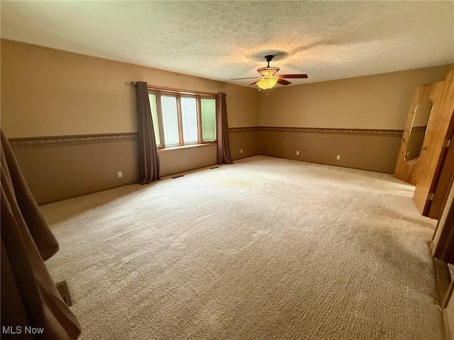 305 Flintwood Dr, Marietta, OH 45750 - unfurnished room featuring carpet, a ceiling fan, and a textured ceiling