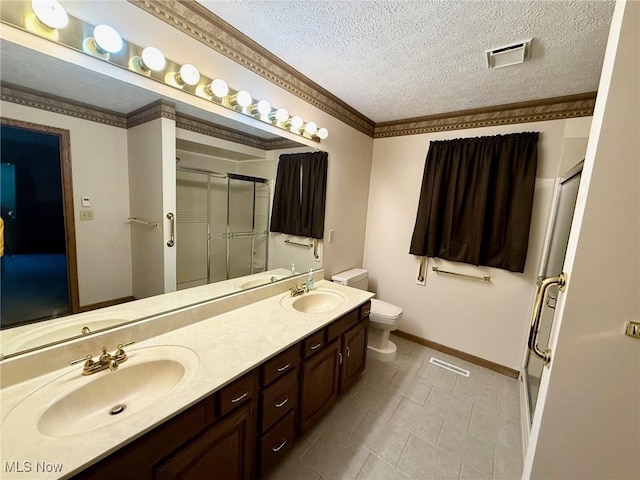 305 Flintwood Dr, Marietta, OH 45750 - full bath with a stall shower, toilet, baseboards, double vanity, and a textured ceiling