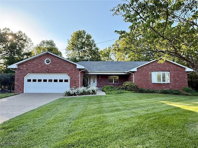 305 Flintwood Dr, Marietta, OH 45750 - single story home featuring a front lawn, an attached garage, brick siding, and driveway