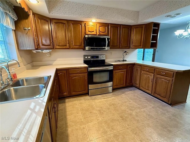 305 Flintwood Dr, Marietta, OH 45750 - kitchen with stainless steel appliances, a sink, a tray ceiling, light tile patterned floors, and recessed lighting