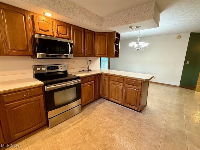 305 Flintwood Dr, Marietta, OH 45750 - kitchen featuring appliances with stainless steel finishes, a peninsula, a chandelier, light countertops, and light tile patterned floors