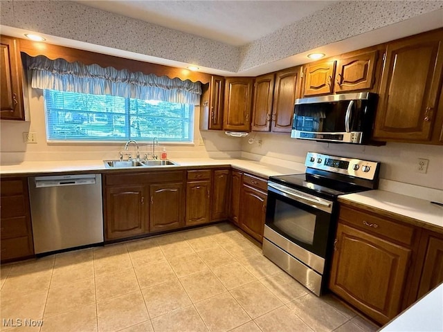 305 Flintwood Dr, Marietta, OH 45750 - kitchen featuring appliances with stainless steel finishes, a sink, light tile patterned floors, light countertops, and recessed lighting
