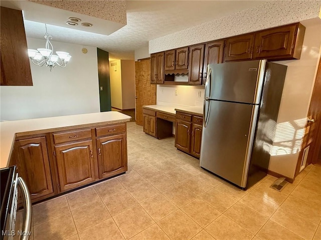 305 Flintwood Dr, Marietta, OH 45750 - kitchen featuring freestanding refrigerator, light countertops, light tile patterned flooring, a peninsula, and a textured ceiling