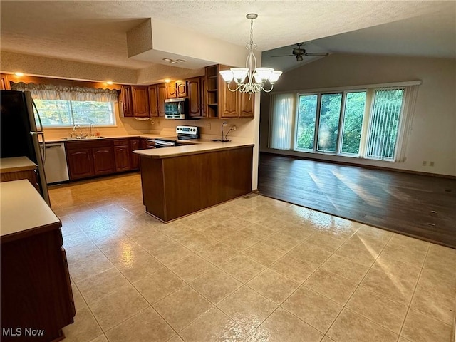 305 Flintwood Dr, Marietta, OH 45750 - kitchen with stainless steel appliances, a chandelier, a sink, open floor plan, and a textured ceiling