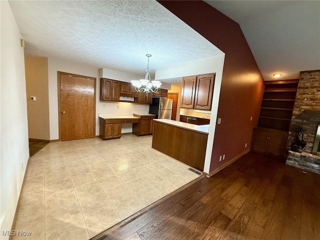 305 Flintwood Dr, Marietta, OH 45750 - kitchen with freestanding refrigerator, a chandelier, light countertops, baseboards, and decorative light fixtures