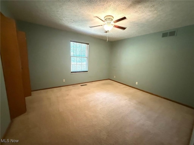 305 Flintwood Dr, Marietta, OH 45750 - spare room featuring ceiling fan, carpet flooring, baseboards, and a textured ceiling