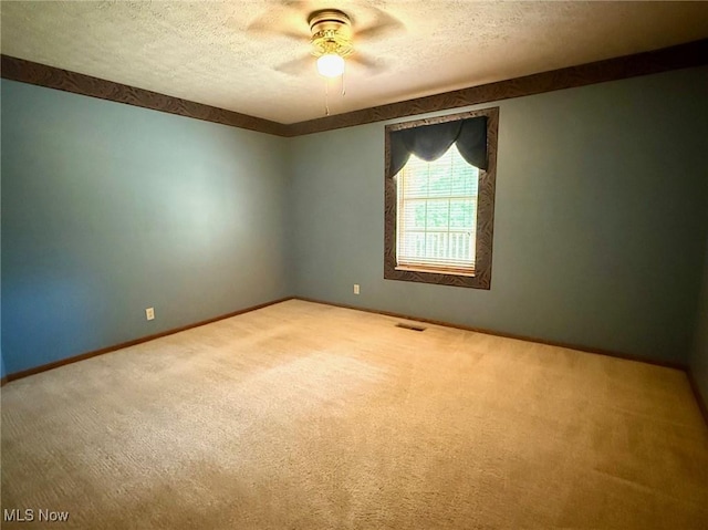 305 Flintwood Dr, Marietta, OH 45750 - spare room featuring carpet flooring, a textured ceiling, ceiling fan, and baseboards