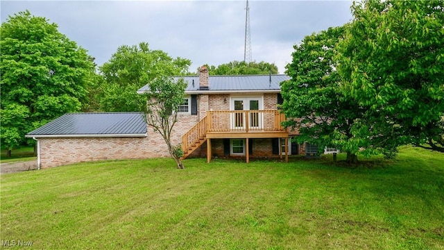 23595 Sandy Creek Rd, Minerva, OH 44657 - rear view of property with stairs, a chimney, a wooden deck, brick siding, and a lawn