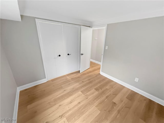 9530 Cove Dr Unit C-26, North Royalton, OH 44133 - unfurnished bedroom with light wood-type flooring, a closet, and baseboards