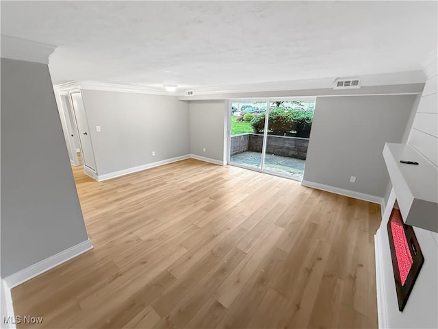 9530 Cove Dr Unit C-26, North Royalton, OH 44133 - spare room featuring baseboards, light wood-style floors, and crown molding