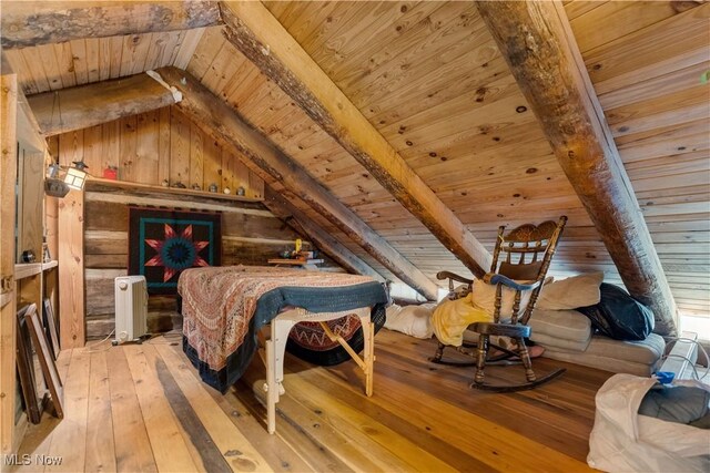 15216 Grove Rd SE, Port Washington, OH 43837 - bedroom with wooden ceiling, radiator heating unit, light wood-type flooring, and wooden walls