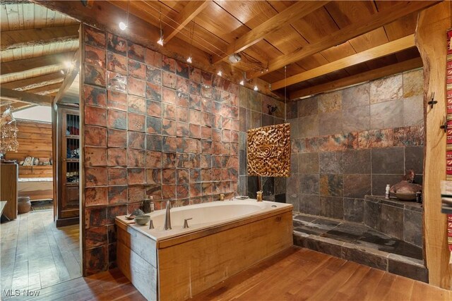 15216 Grove Rd SE, Port Washington, OH 43837 - bathroom with wooden ceiling with exposed beams, hardwood / wood-style floors, a garden tub, tile walls, and tiled shower