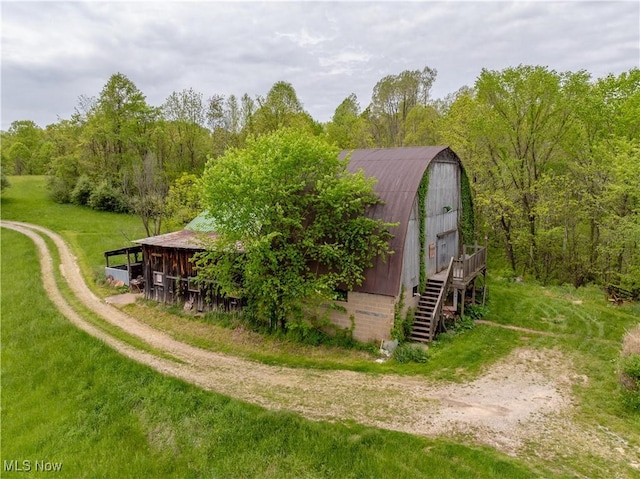 15216 Grove Rd SE, Port Washington, OH 43837 - view of barn featuring stairs, a yard, and a wooded view