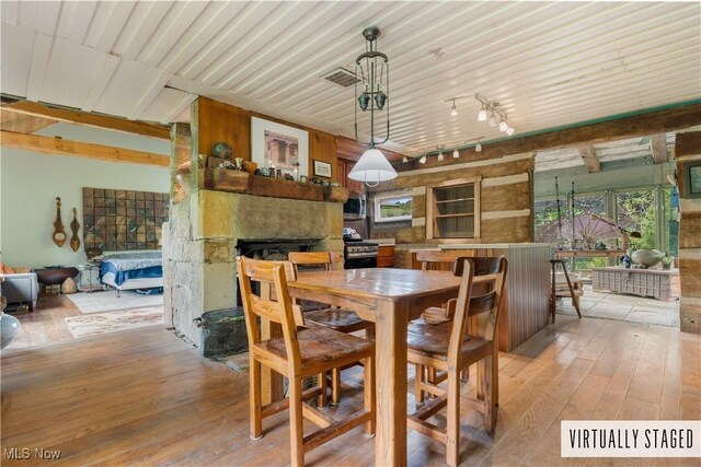 15216 Grove Rd SE, Port Washington, OH 43837 - dining area featuring wood-type flooring, a fireplace, and track lighting