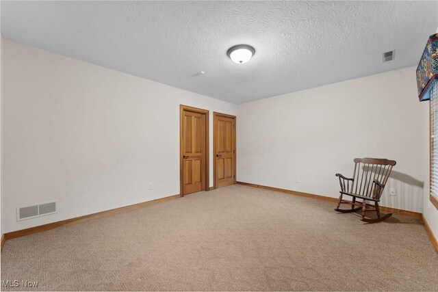 3109 Kennesaw Cir NW, Canton, OH 44708 - unfurnished room with light carpet, baseboards, and a textured ceiling
