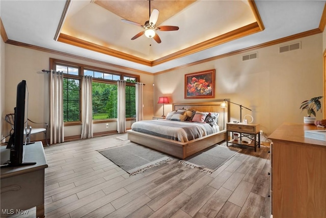 3109 Kennesaw Cir NW, Canton, OH 44708 - bedroom with a tray ceiling, wood finished floors, crown molding, baseboards, and ceiling fan