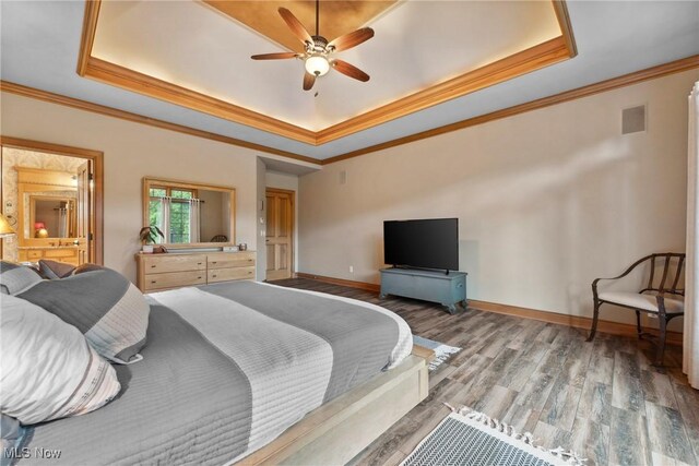 3109 Kennesaw Cir NW, Canton, OH 44708 - bedroom featuring a tray ceiling, crown molding, wood finished floors, baseboards, and ceiling fan