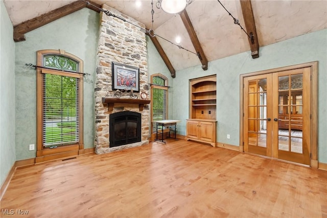3109 Kennesaw Cir NW, Canton, OH 44708 - living room with light wood-style floors, high vaulted ceiling, a fireplace, french doors, and beam ceiling