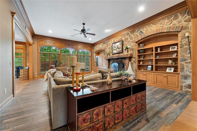 3109 Kennesaw Cir NW, Canton, OH 44708 - living room featuring crown molding, a ceiling fan, hardwood / wood-style floors, a stone fireplace, and baseboards