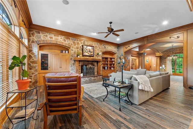 3109 Kennesaw Cir NW, Canton, OH 44708 - living area with arched walkways, a ceiling fan, decorative columns, crown molding, and wood finished floors