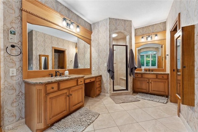 3109 Kennesaw Cir NW, Canton, OH 44708 - full bath with wallpapered walls, a stall shower, two vanities, tile patterned floors, and baseboards