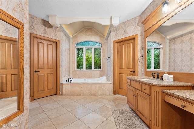 3109 Kennesaw Cir NW, Canton, OH 44708 - bathroom featuring wallpapered walls, a garden tub, vanity, lofted ceiling, and tile patterned flooring