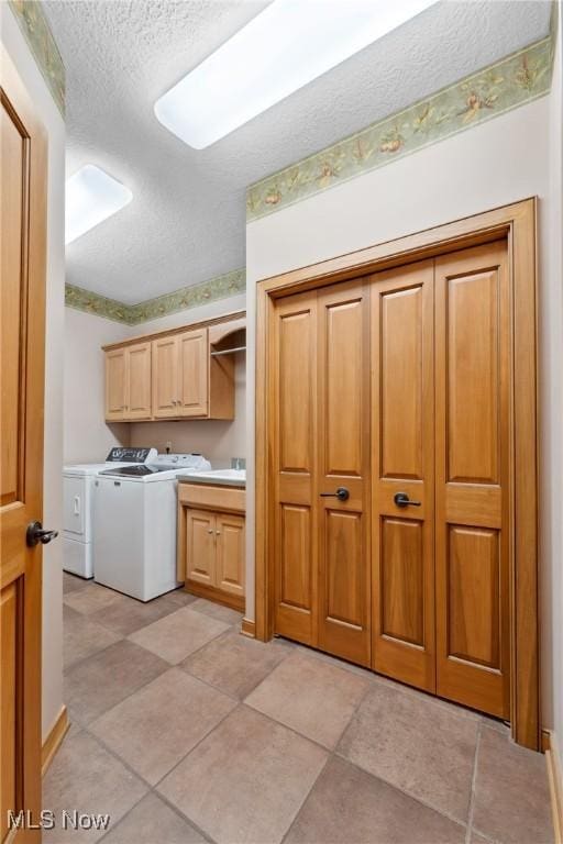 3109 Kennesaw Cir NW, Canton, OH 44708 - washroom featuring cabinet space, a textured ceiling, and washer and dryer