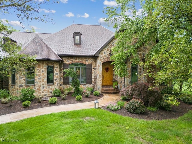 3109 Kennesaw Cir NW, Canton, OH 44708 - view of front facade featuring stone siding, a front yard, and roof with shingles