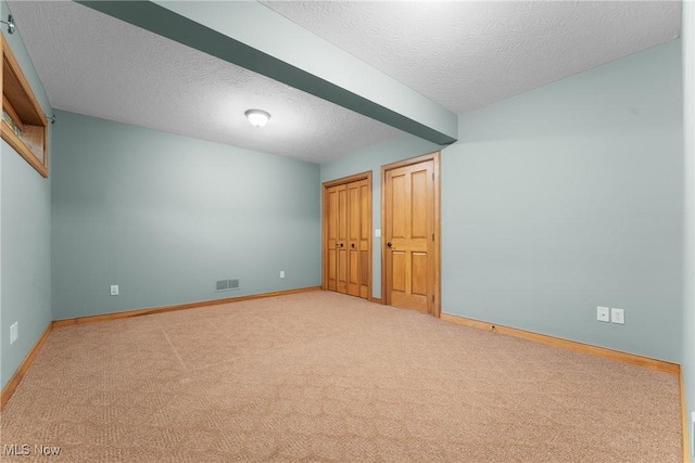 3109 Kennesaw Cir NW, Canton, OH 44708 - unfurnished bedroom featuring a textured ceiling, carpet flooring, baseboards, and two closets