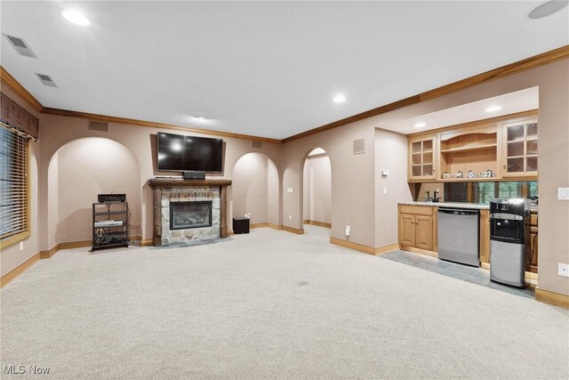 3109 Kennesaw Cir NW, Canton, OH 44708 - unfurnished living room featuring ornamental molding, baseboards, recessed lighting, a fireplace with flush hearth, and bar with sink