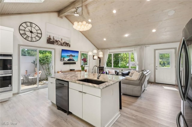 179 High St, Chagrin Falls, OH 44022 - kitchen featuring appliances with stainless steel finishes, a sink, an island with sink, light wood-type flooring, and high vaulted ceiling