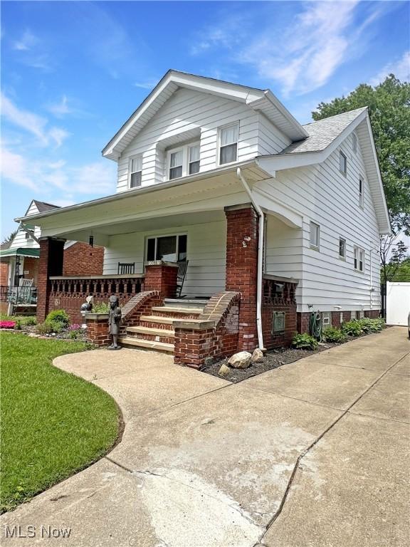 9007 Plymouth Ave, Garfield Heights, OH 44125 - view of front of house featuring a porch and brick siding