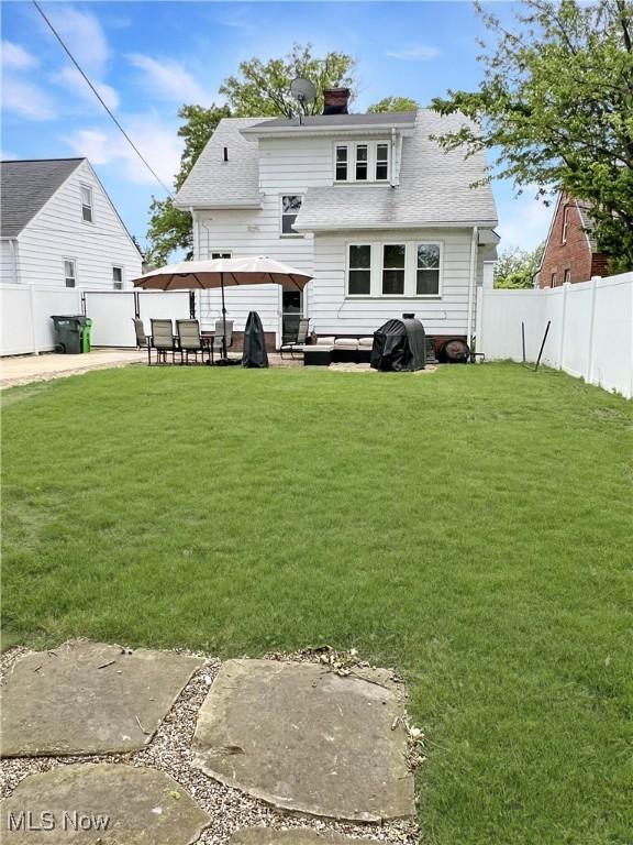 9007 Plymouth Ave, Garfield Heights, OH 44125 - rear view of property featuring a patio, a shingled roof, a chimney, and a gazebo