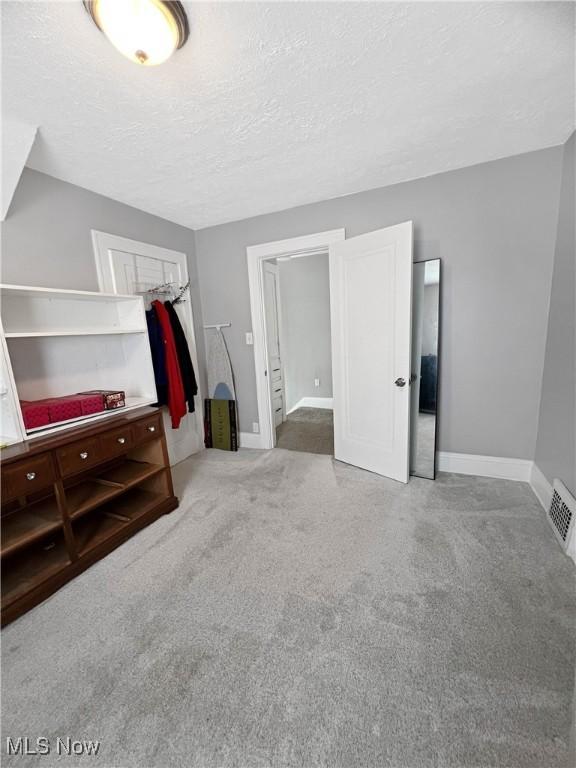 9007 Plymouth Ave, Garfield Heights, OH 44125 - bonus room with carpet flooring, baseboards, and a textured ceiling