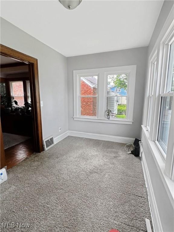9007 Plymouth Ave, Garfield Heights, OH 44125 - spare room with carpet floors, healthy amount of natural light, and baseboards