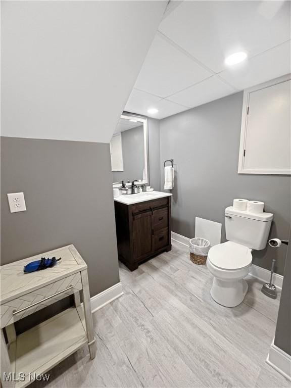 9007 Plymouth Ave, Garfield Heights, OH 44125 - bathroom with toilet, vanity, wood finished floors, and baseboards