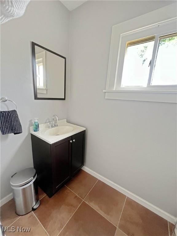 9007 Plymouth Ave, Garfield Heights, OH 44125 - bathroom with vanity, baseboards, tile patterned floors, and toilet