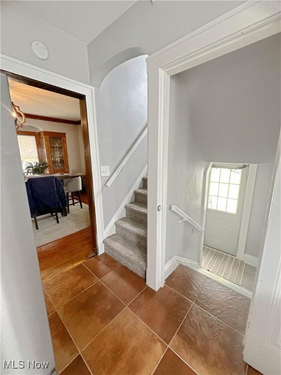 9007 Plymouth Ave, Garfield Heights, OH 44125 - stairway featuring healthy amount of natural light and tile patterned floors