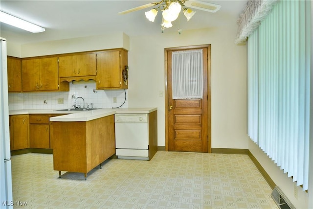 3763 E River Rd, Newton Falls, OH 44444 - kitchen featuring white dishwasher, a sink, light flooring, and brown cabinetry