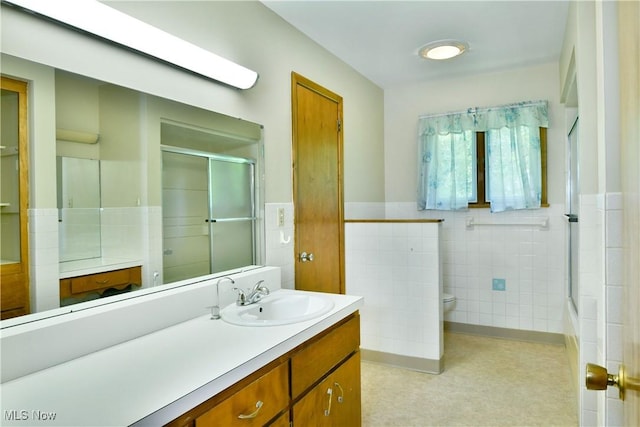 3763 E River Rd, Newton Falls, OH 44444 - full bathroom with tile walls, a shower with shower door, vanity, toilet, and a wainscoted wall