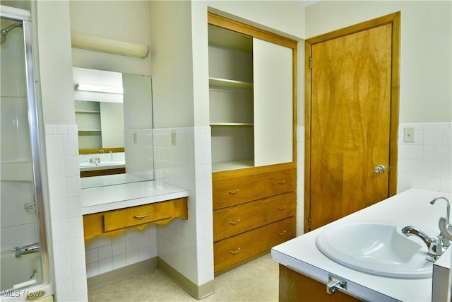 3763 E River Rd, Newton Falls, OH 44444 - full bathroom with vanity, tile walls, and wainscoting
