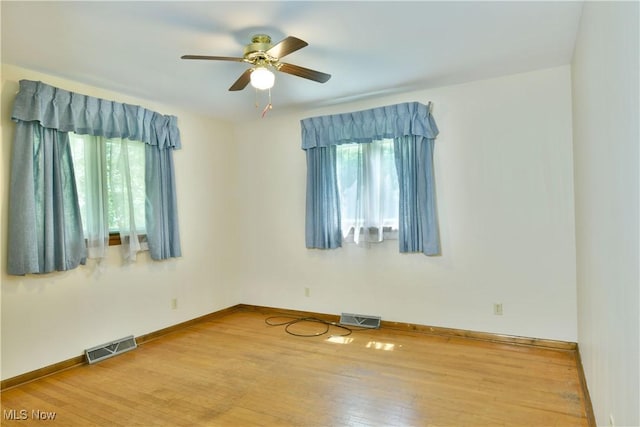 3763 E River Rd, Newton Falls, OH 44444 - empty room with healthy amount of natural light, a ceiling fan, wood finished floors, and baseboards