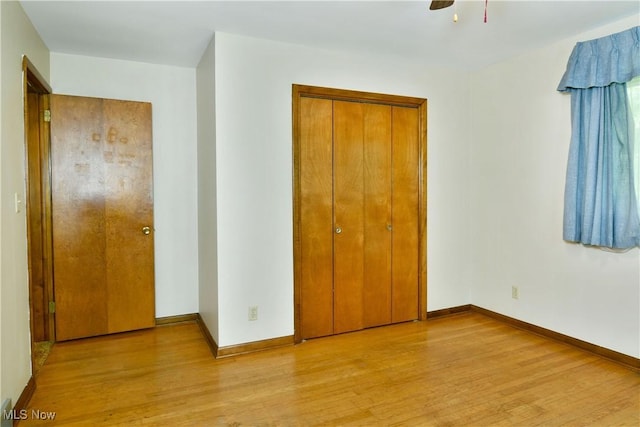 3763 E River Rd, Newton Falls, OH 44444 - unfurnished bedroom with light wood-style flooring, a closet, baseboards, and ceiling fan