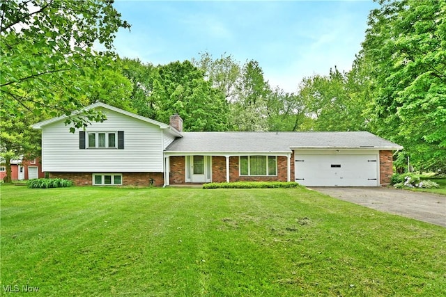 3763 E River Rd, Newton Falls, OH 44444 - split level home featuring asphalt driveway, an attached garage, a chimney, and a front lawn