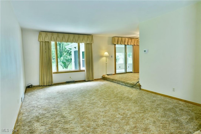 3763 E River Rd, Newton Falls, OH 44444 - unfurnished room featuring carpet flooring, healthy amount of natural light, and baseboards