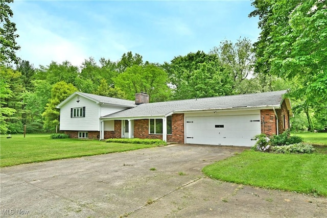 3763 E River Rd, Newton Falls, OH 44444 - split level home with a chimney, an attached garage, concrete driveway, brick siding, and a front yard