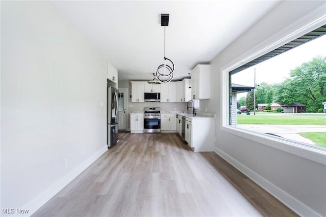 351 Cranberry Run, Boardman, OH 44512 - kitchen with stainless steel appliances, light countertops, light wood-style floors, and baseboards